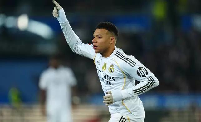 Real Madrid's Kylian Mbappe celebrates after scoring the opening goal during the Spanish La Liga soccer match between Alaves and Real Madrid in Vitoria-Gasteiz, Spain, Sunday, Dec. 14, 2025. (AP Photo/Miguel Oses)