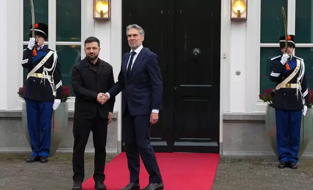 Dutch Prime Minister Dick Schoof, center, welcomes Ukraine's President Volodymyr Zelenskyy in The Hague, Netherlands, Tuesday, Dec. 16, 2025. (AP Photo/Peter Dejong)