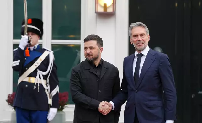 Dutch Prime Minister Dick Schoof, right, welcomes Ukraine's President Volodymyr Zelenskyy in The Hague, Netherlands, Tuesday, Dec. 16, 2025. (AP Photo/Peter Dejong)