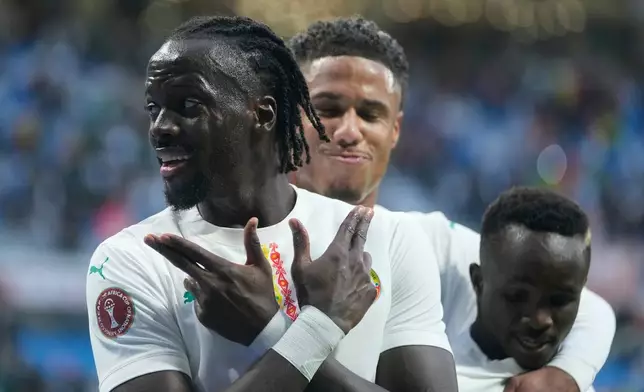 Senegal's Cherif Ndiaye, left, and Cheikh Sabaly celebrate after a goal during the Africa Cup of Nations group D soccer match between Senegal and Botswana in Tangier, Morocco, Tuesday, Dec. 23, 2025. (AP Photo/Mosa'ab Elshamy)