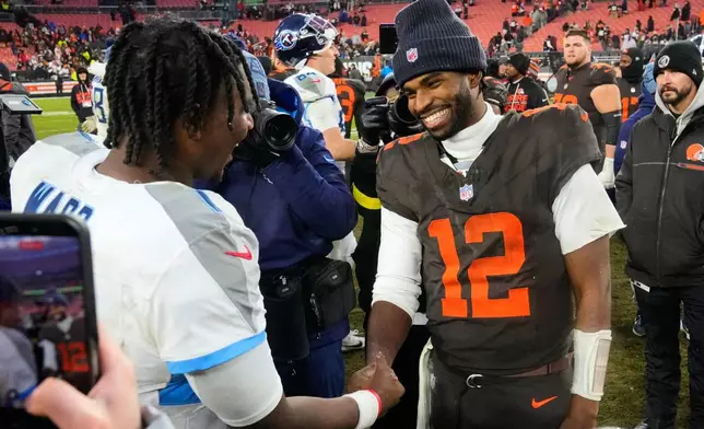 Tennessee Titans quarterback Cam Ward, left, and Cleveland Browns quarterback Shedeur Sanders (12) greet each other after an NFL football game in Cleveland, Sunday, Dec. 7, 2025. (AP Photo/Sue Ogrocki)