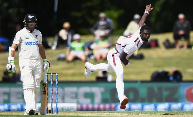West Indies' Jayden Seales, right, bowls against New Zealand on day 3 during their cricket test match in Christchurch, New Zealand, Thursday, Dec. 4, 2025. (Chris Symes/Photosport via AP)