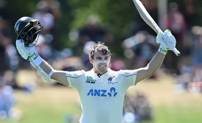 New Zealand's Tom Latham celebrates after making 100 runs against the West Indies on day 3 during their cricket test match in Christchurch, New Zealand, Thursday, Dec. 4, 2025. (Andrew Cornaga/Photosport via AP)