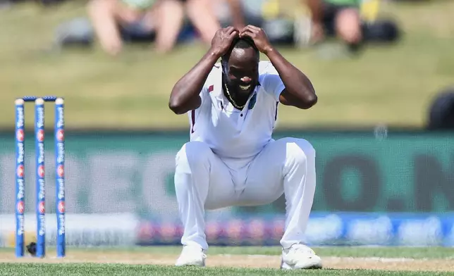 West Indies' Kemar Roach crouches after bowling against New Zealand on day 3 during their cricket test match in Christchurch, New Zealand, Thursday, Dec. 4, 2025. (Chris Symes/Photosport via AP)