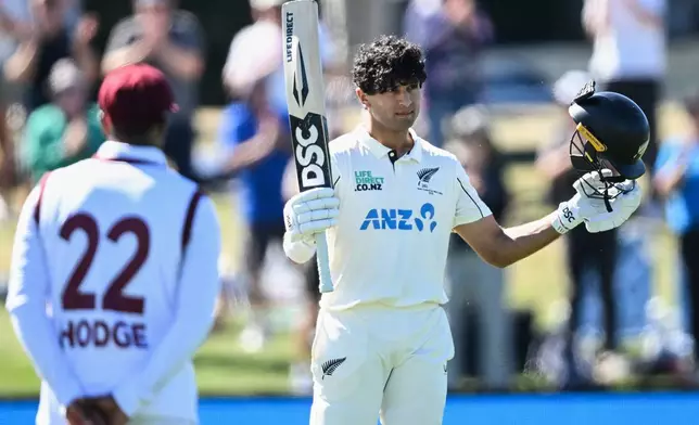 New Zealand's Rachin Ravindra celebrates after making 100 runs against the West Indies on day 3 during their cricket test match in Christchurch, New Zealand, Thursday, Dec. 4, 2025. (Andrew Cornaga/Photosport via AP)