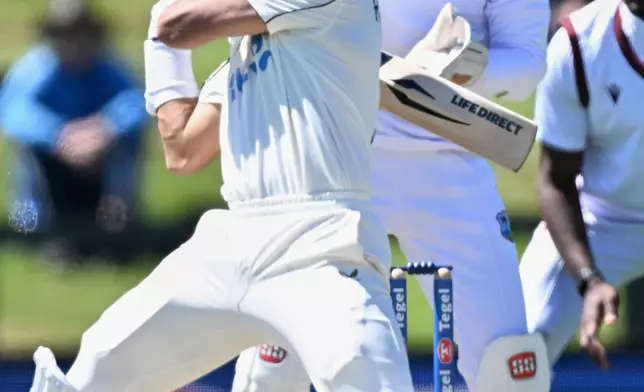 New Zealand's Rachin Ravindra, left, bats against the West Indies on day 3 during their cricket test match in Christchurch, New Zealand, Thursday, Dec. 4, 2025. (Andrew Cornaga/Photosport via AP)