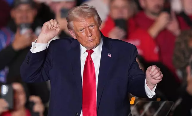 President Donald Trump dances to music after speaking at the Mount Airy Casino Resort in Mount Pocono, Pa., Tuesday, Dec. 9, 2025. (AP Photo/Matt Rourke)