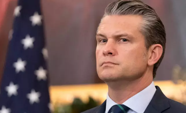 Defense Secretary Pete Hegseth listens during an event at the State Department, Monday, Dec. 8, 2025, in Washington. (AP Photo/Mark Schiefelbein)