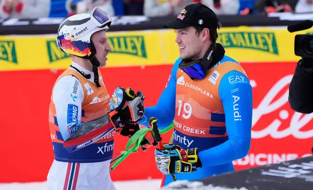 Norway's Henrik Kristoffersen shakes hands with Italy's Alex Vinatzer at the finish line during a World Cup men's giant slalom skiing race, Sunday, Dec. 7, 2025, in Beaver Creek, Colo. (AP Photo/John Locher)