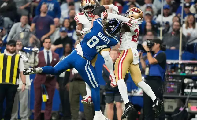 Indianapolis Colts tight end Tyler Warren (84) cannot catch a pass while being defended by San Francisco 49ers cornerback Upton Stout, top left, and cornerback Darrell Luter Jr. during the first half of an NFL football game, Monday, Dec. 22, 2025, in Indianapolis. (AP Photo/Carolyn Kaster)