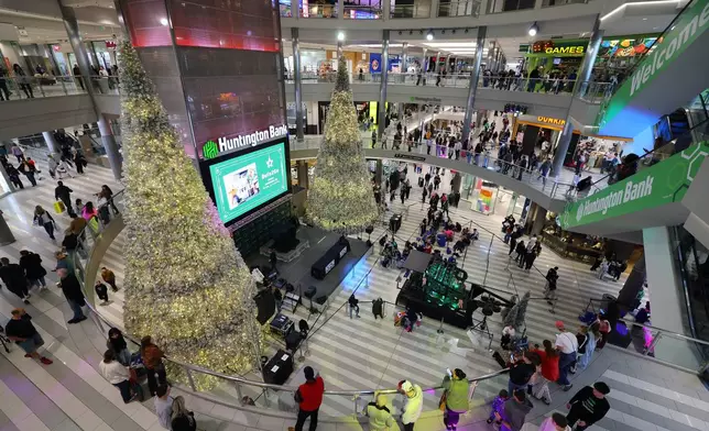 Shoppers browse through stores at Mall of America for Black Friday deals, Friday, Nov. 28, 2025, in Bloomington, Minn. (AP Photo/Adam Bettcher)