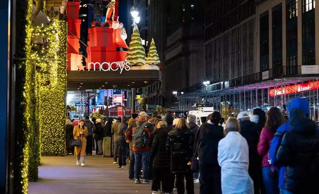 Black Friday Shoppers wait in line to enter Macy's flagship store on Friday, Nov. 28, 2025 in New York. (AP Photo/Angelina Katsanis)