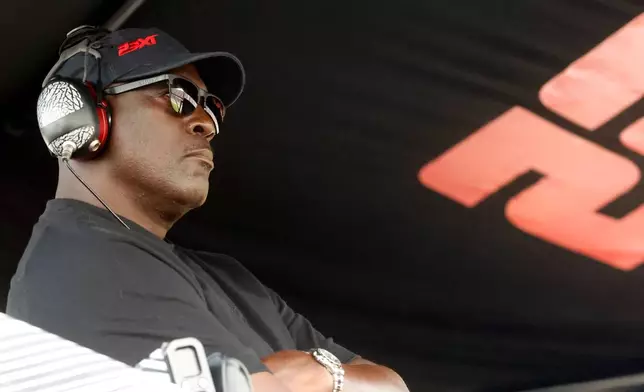 FILE - Michael Jordan, co-owner of 23XI Racing, sits in his pit box during a NASCAR Cup Series auto race at Talladega Superspeedway, Sunday, Oct. 6, 2024, in Talladega, Ala. (AP Photo/ Butch Dill, File)