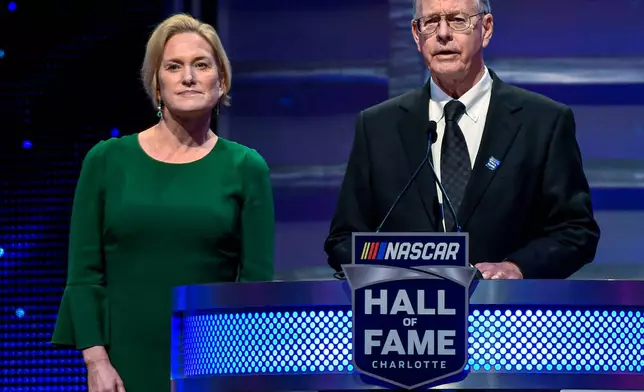 FILE - CEO and Chairman of NASCAR Jim France, right, along with the Executive Vice President of NASCAR Lesa Kennedy announce the Landmark Award to Edsel Ford II the Hall of Fame induction ceremony in Charlotte, N.C. Jan. 31, 2020. (AP Photo/Mike McCarn, File)