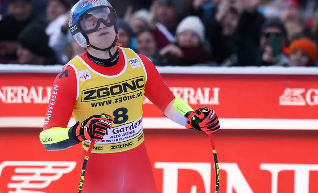 Switzerland's Marco Odermatt at the finish area of an alpine ski, men's World Cup super-G, in Val Gardena, France, Friday, Dec.19, 2025. (AP Photo/Alessandro Trovati)