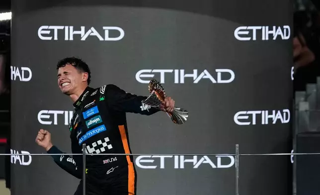 McLaren driver Lando Norris of Britain celebrates after becoming a world champion after the Formula One Abu Dhabi Grand Prix at the Yas Marina Circuit in Abu Dhabi, UAE, Sunday, Dec. 7, 2025. (AP Photo/Altaf Qadri)