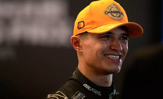 McLaren driver Lando Norris of Britain smiles after becoming a world champion after the Formula One Abu Dhabi Grand Prix at the Yas Marina Circuit in Abu Dhabi, UAE, Sunday, Dec. 7, 2025. (AP Photo/Fatima Shbair)