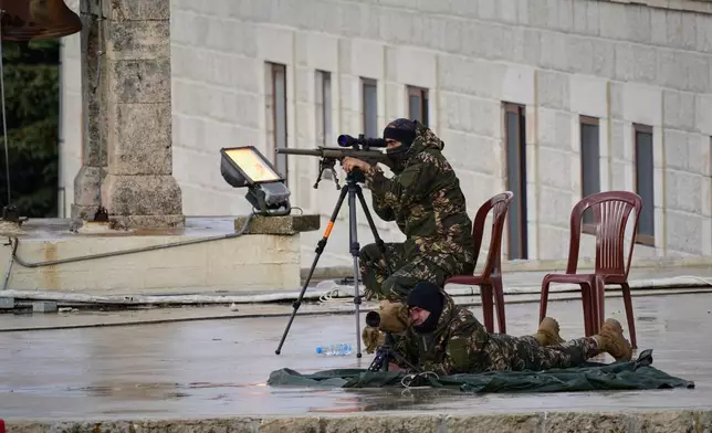 Lebanese security personnel deploy on the roof of the Monastery of Saint Maroun ahead of Pope Leo XIV's arrival in Annaya, Lebanon, Monday, Dec. 1, 2025. (AP Photo/Hassan Ammar)