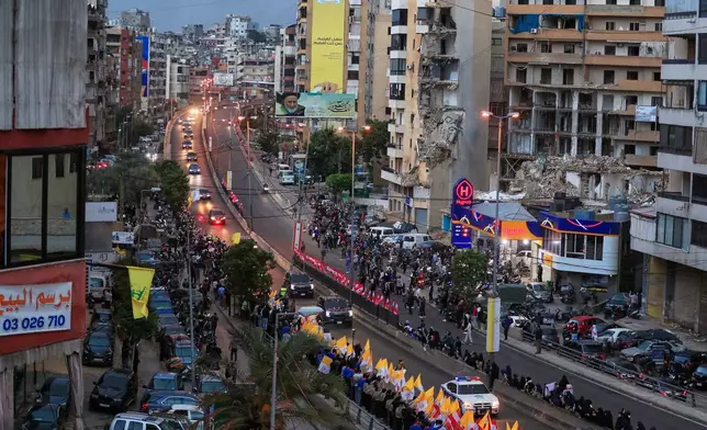 The convoy escorting Pope Leo XIV drives past war-damaged buildings in Beirut, Lebanon, Sunday, Nov. 30, 2025, following his arrival. (AP Photo/Mohammed Zaatari)