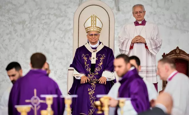 Pope Leo XIV sits as he celebrates a Holy Mass at Beirut waterfront, in Beirut, Lebanon, Tuesday, Dec. 2, 2025. (AP Photo/Bilal Hussein)