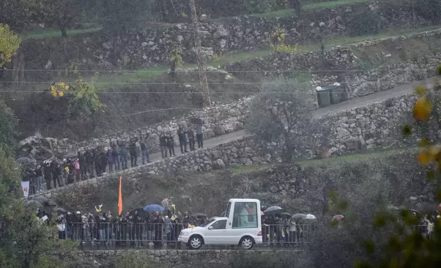 The popemobile carrying Pope Leo XIV arrives at the Monastery of Saint Maroun in Annaya, Lebanon, Monday, Dec. 1, 2025. (AP Photo/Hassan Ammar)