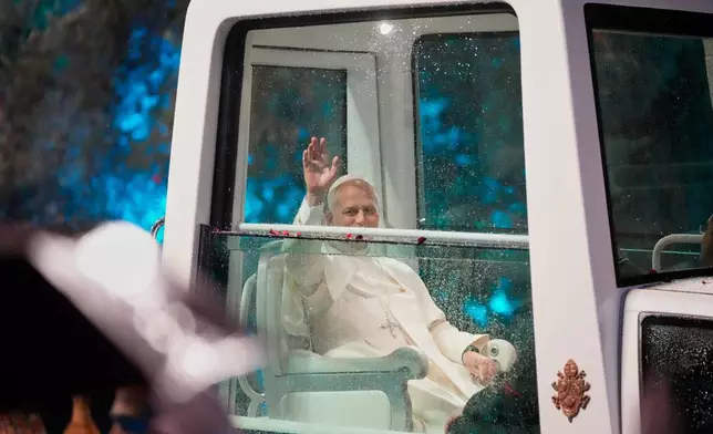 Pope Leo XIV waves as he arrives for a welcoming ceremony at the presidential palace in Baabda, east of Beirut, Lebanon, Sunday, Nov. 30, 2025.(AP Photo/Hassan Ammar)