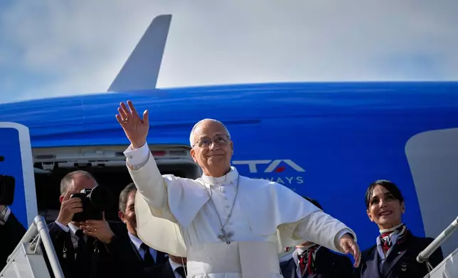Pope Leo XIV waves as he boards a flight back to the Vatican after his visit to Lebanon at Beirut International Airport in Beirut, Lebanon, Tuesday, Dec. 2, 2025. (AP Photo/Hussein Malla)
