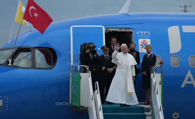 Pope Leo XIV waves as he boards a plane bound to Beirut, Lebanon, at Ataturk airport, in Istanbul, Turkey, Sunday, Nov. 30, 2025. (AP Photo/Dilara Acikgoz)