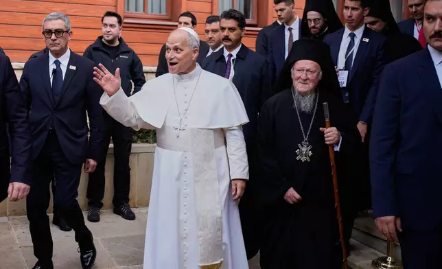 Pope Leo XIV and Ecumenical Patriarch Bartholomew I, the spiritual leader of the world's Eastern Orthodox Christians, leave after a joint Ecumenical blessing at the Patriarchal Church of Saint George, in Istanbul, Turkey, Sunday, Nov. 30, 2025. (AP Photo/Emrah Gurel)