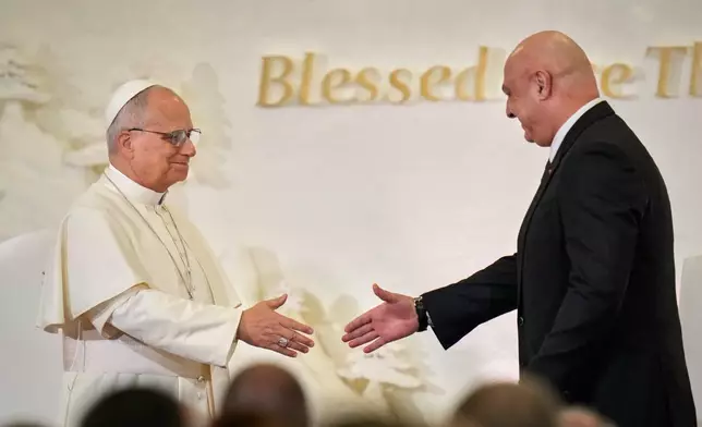 Lebanese President Joseph Aoun, right, shakes hands with Pope Leo XIV as they meet at the presidential palace in Baabda, east of Beirut, Lebanon, Sunday, Nov. 30, 2025.(AP Photo/Hassan Ammar)