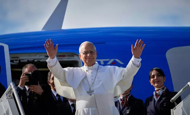 Pope Leo XIV waves as he boards a flight back to the Vatican after his visit to Lebanon at Beirut International Airport in Beirut, Lebanon, Tuesday, Dec. 2, 2025. (AP Photo/Hussein Malla)