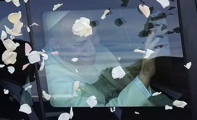 Rose petals are scattered to Pope Leo XIV as he leaves after visiting the Psychiatric Hospital of the Cross in the town of Jal el-Dib, north of Beirut, Lebanon, Tuesday, Dec. 2, 2025. (AP Photo/Hassan Ammar)