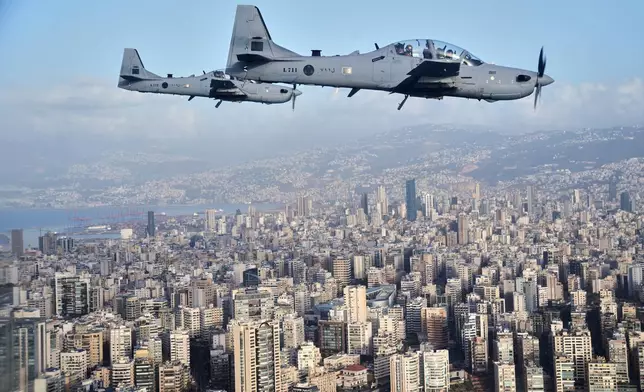 Two Lebanese air force fighters escort Pope Leo XIV's plane as it flies over Beirut, Lebanon, on it's way to the international airport, Sunday, Nov. 30, 2025. (AP Photo/Domenico Stinellis)