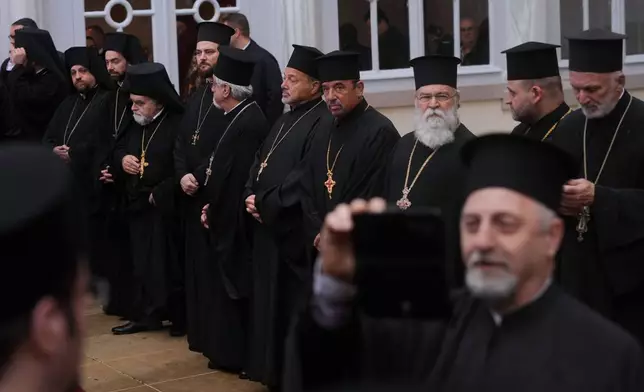 Orthodox clerics wait for Pope Leo XIV to arrive for a doxology service at the Patriarchal Church of Saint George, in Istanbul, Turkey, Saturday, Nov. 29, 2025. (AP Photo/Francisco Seco)