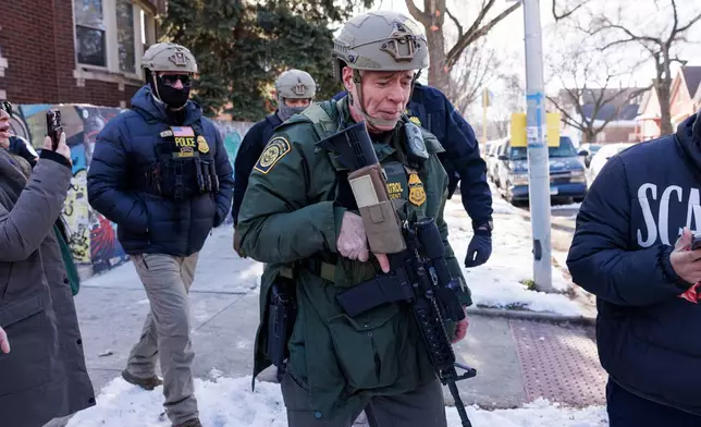 Border Patrol Cmdr. Gregory Bovino walks alongside his agents after they detain an individual near West 27th Street and South Ridgeway Avenue in the Little Village neighborhood of Chicago, Tuesday, Dec. 16, 2025. (Anthony Vazquez/Chicago Sun-Times via AP)
