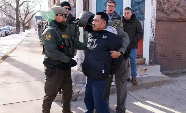 Federal immigration enforcement agents detain an individual near West 27th Street and South Ridgeway Avenue in the Little Village neighborhood of Chicago, Tuesday, Dec. 16, 2025. (Anthony Vazquez/Chicago Sun-Times via AP)