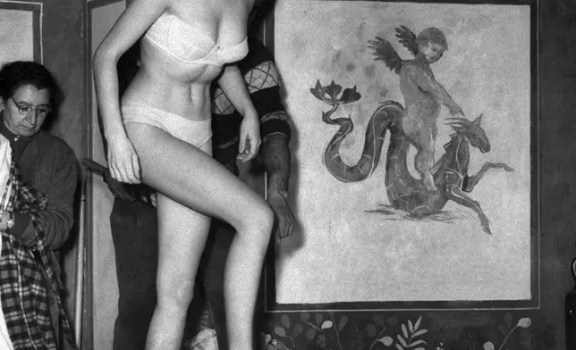 FILE - French actress Brigitte Bardot steps into a milk bath while filming the comedy "Nero's Big Weekend," in Rome March 27, 1956. (AP Photo/File)