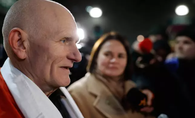 Nobel Peace Prize laureate Ales Bialiatski, one of released Belarusian prisoners, arrives at the U.S. Embassy in Vilnius, Lithuania, on Saturday, Dec. 13, 2025, as Belarusian opposition leader Sviatlana Tsikhanouskaya, background stands near. (AP Photo/Mindaugas Kulbis)
