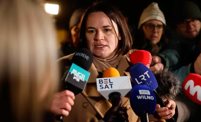 Belarusian opposition leader Sviatlana Tsikhanouskaya speaks to journalists as she waits to meet released Belarusian prisoners at the U.S. Embassy in Vilnius, Lithuania, on Saturday, Dec. 13, 2025. (AP Photo/Mindaugas Kulbis)