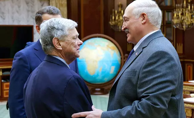 In this photo released by Belarusian presidential press service, Belarusian President Alexander Lukashenko, right, and U.S. Presidential envoy John Coale shake hands during their meeting in Minsk, Belarus, Friday, Dec. 12, 2025. (Belarusian Presidential Press Service via AP)