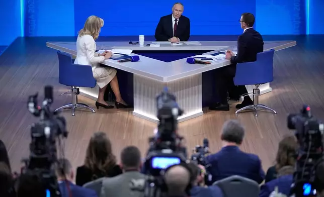 Russian President Vladimir Putin, center, speaks during his annual news conference and call-in show at Gostinny Dvor, in Moscow, on Friday, Dec. 19, 2025. (AP Photo/Pavel Bednyakov)
