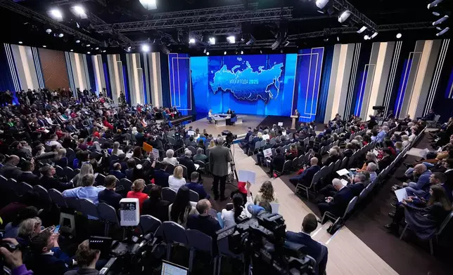 Russian President Vladimir Putin, background center, speaks during his annual news conference and call-in show at Gostinny Dvor, in Moscow, on Friday, Dec. 19, 2025. (AP Photo/Pavel Bednyakov)