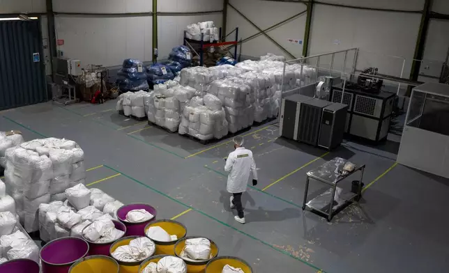 A worker walks inside a cooperative that is licensed to produce and sell CBD and medicinal cannabis products, near Bab Berred, Chefchaouen, Morocco, Monday, Nov. 24, 2025. (AP Photo/Mosa'ab Elshamy)