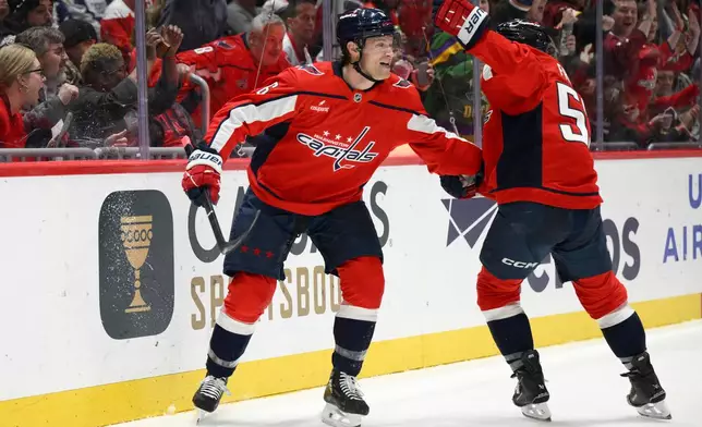 Washington Capitals defenseman Jakob Chychrun, left, celebrates his goal with center Ethen Frank during the first period of an NHL hockey game against the Toronto Maple Leafs, Thursday, Dec. 18, 2025, in Washington. (AP Photo/Nick Wass)