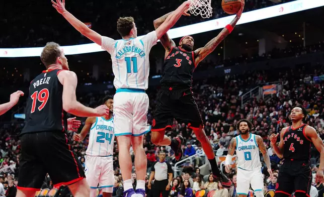 Toronto Raptors' Brandon Ingram (3) shoots past Charlotte Hornets' Ryan Kalkbrenner (11) during second half NBA basketball action in Toronto on Friday, Dec. 5, 2025. (Frank Gunn/The Canadian Press via AP)