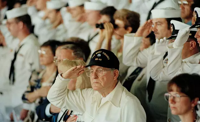 FILE - Pearl Harbor survivor Archie Odom, of Federal Way, Wash., salutes during a moment of silence in Pearl Harbor, Hawaii, Dec. 7, 1991, in remembrance of those killed during the Japanese attack on Pearl Harbor. Odom was a signalman on the bridge of the USS West Virginia when the Japanese attacked. (AP Photo/John Gaps III, File)