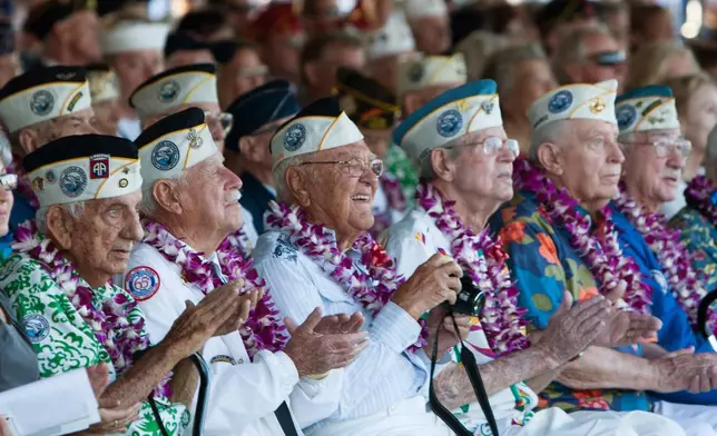 FILE - Pearl Harbor survivors watch a vintage WWII airplane fly over Pearl Harbor at the ceremony commemorating the 72nd anniversary of the attack on Pearl Harbor, Dec. 7, 2013, in Honolulu. (AP Photo/Marco Garcia, File)