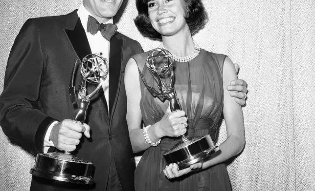 FILE - This May 25, 1964 file photo shows Dick Van Dyke, left, and Mary Tyler Moore, co-stars of "The Dick Van Dyke Show" backstage at the Palladium with their Emmys for best actor and actress in a series at the Television Academy's 16th annual awards show, in Los Angeles. (AP Photo, File)