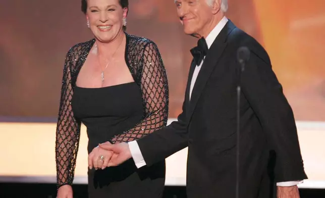 FILE - Julie Andrews, left, is joined by presenter Dick Van Dyke after accepting the 43rd annual life achievement award at the 13th Annual Screen Actors Guild Awards on Sunday, Jan. 28, 2007, in Los Angeles. (AP Photo/Mark J. Terrill, File)