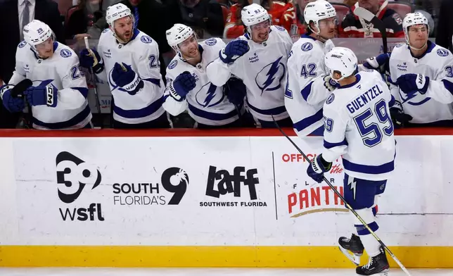 Tampa Bay Lightning center Jake Guentzel (59) celebrates with teammates after his goal against the Florida Panthers during the first period of an NHL hockey game, Saturday, Dec. 27, 2025, in Sunrise, Fla. (AP Photo/Rhona Wise)